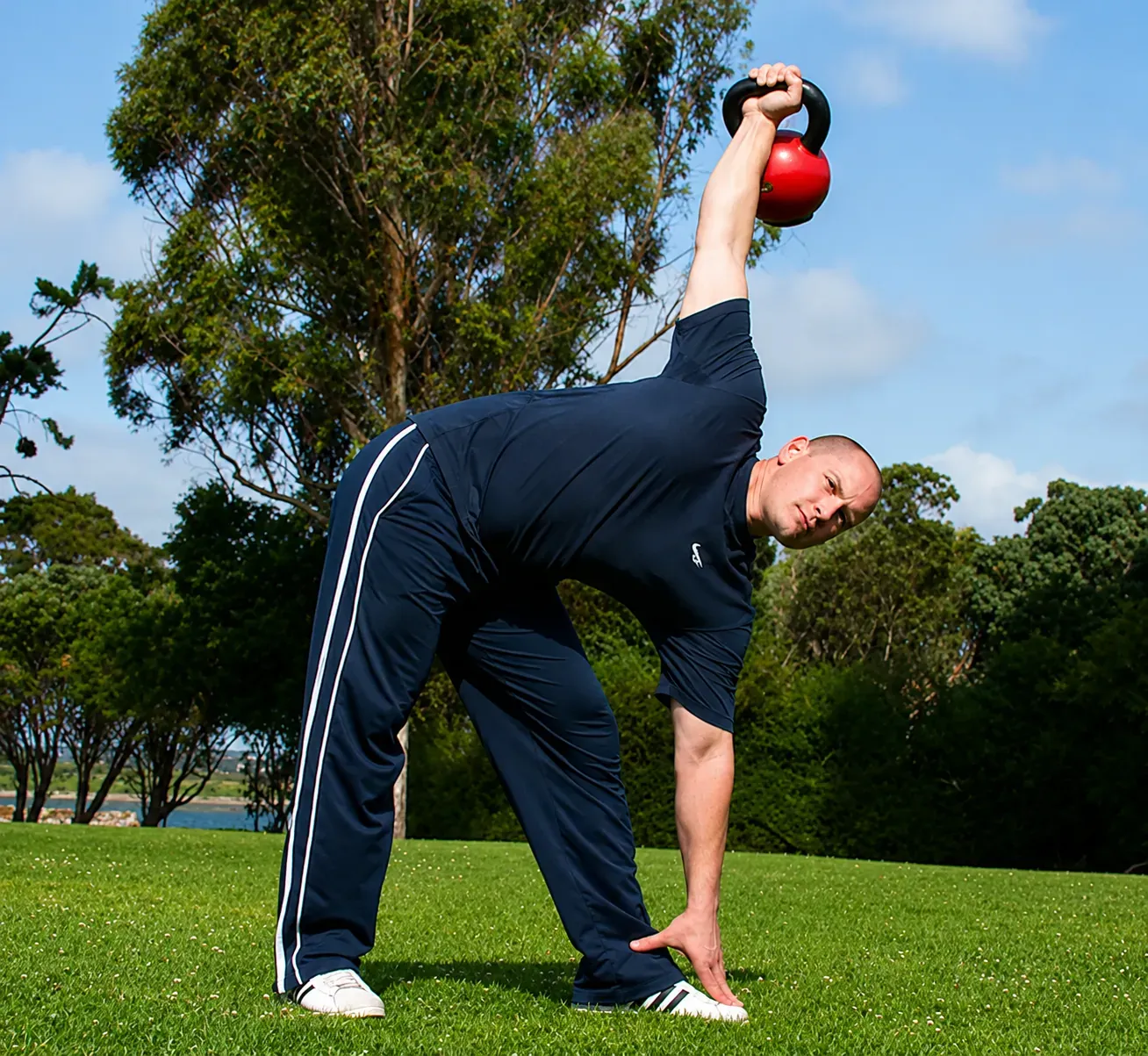 Jeremy NyQuist performing a kettlebell side press