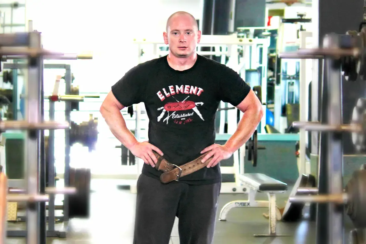 Jeremy NyQuist coaching a client at the squat rack